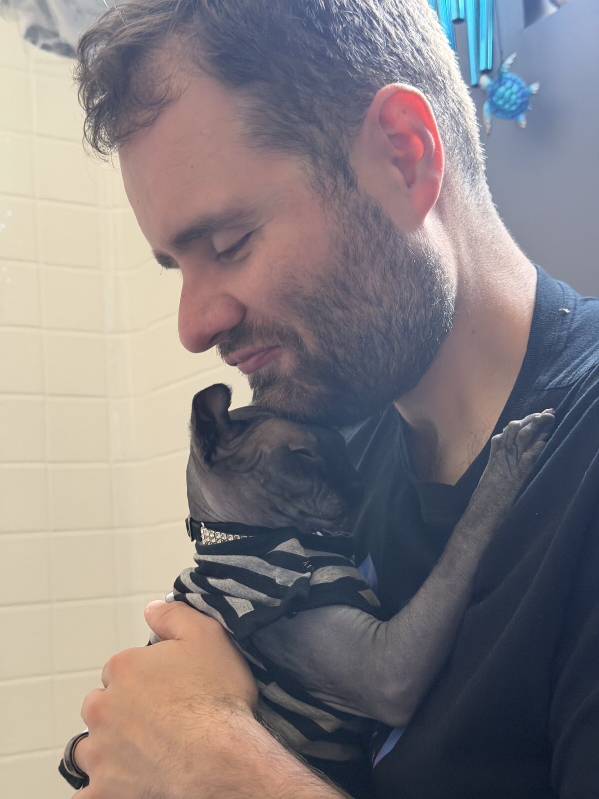Phil holding Anubis close, the two of them nose to nose